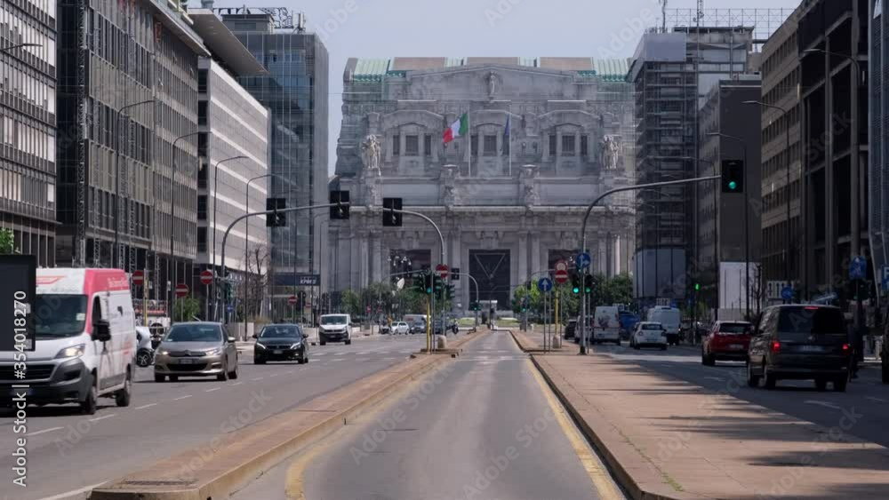 Milan, Lombardy / Italy - May, 28th 2020: Milan Central Station main road with people cycling. Back to life after Coronavirus lockdown. Milan, Lombardy / Italy - May, 28th 2020: Milan Central Station main road with people cycling. Back to life after Coronavirus lockdown.