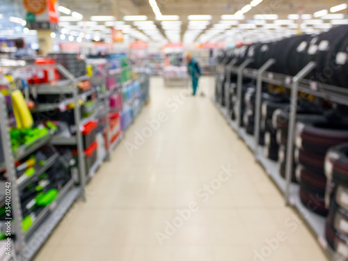 Blurred background in a supermarket. Soft focus on display in the store. Car tires with soft focus.