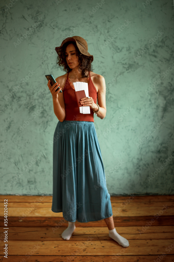 The girl with the documents refer to the information on the phone The girl with the documents refer to the information on the phone