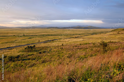 Sunset steppe landscape. Outskirts of Khasan town. Primorsky Krai (Primorye), Far East, Russia.