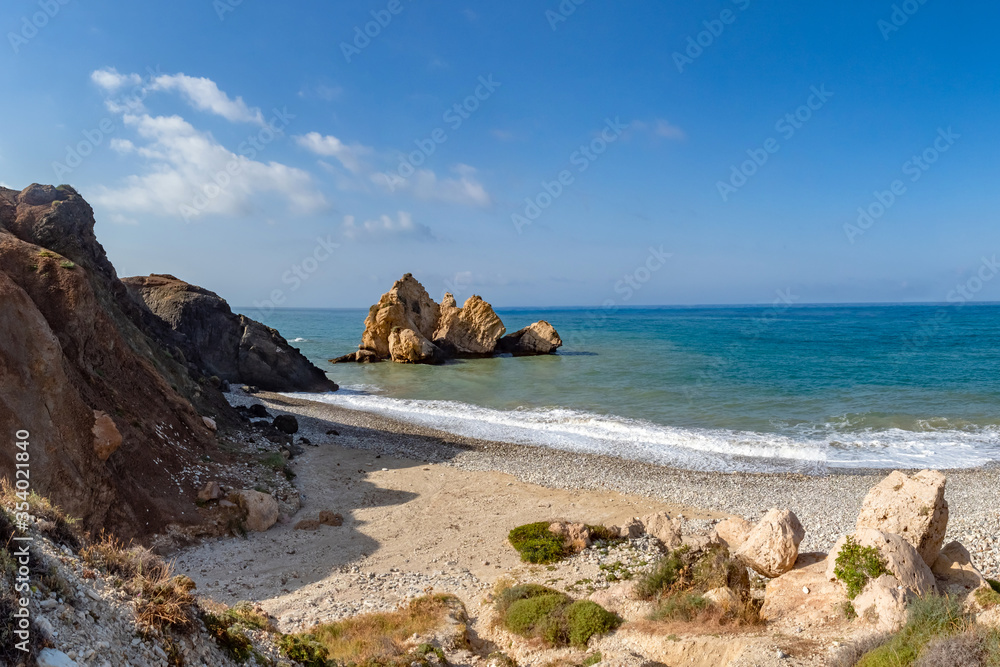 Cyprus beach. Rock of aphrodite. Beach in the Mediterranean Sea. Petra tou Romiu. Landscape of Cyprus coast. Holidays on the beaches of Republic of Cyprus. Excursions to the stone of Aphrodite.
