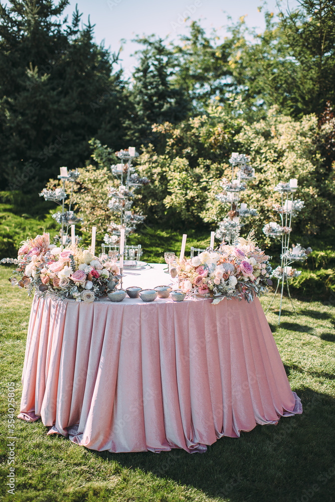 Presidium, table of the newlyweds. Floral arrangements of pink roses ...