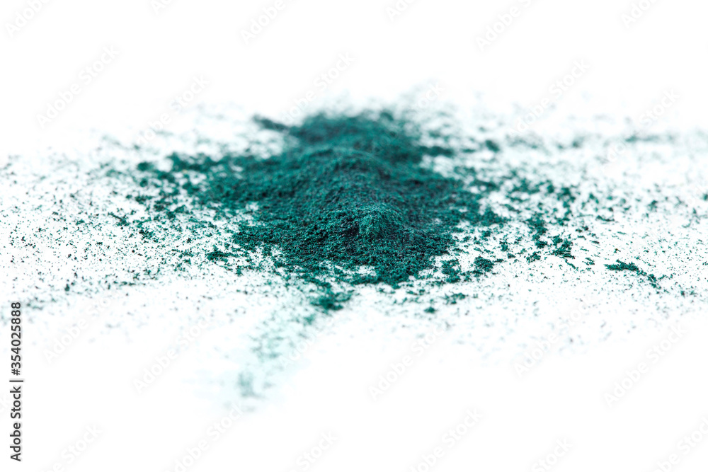 Fototapeta premium Splash of spirulina algae powder isolated on a white background. Superfood concept.