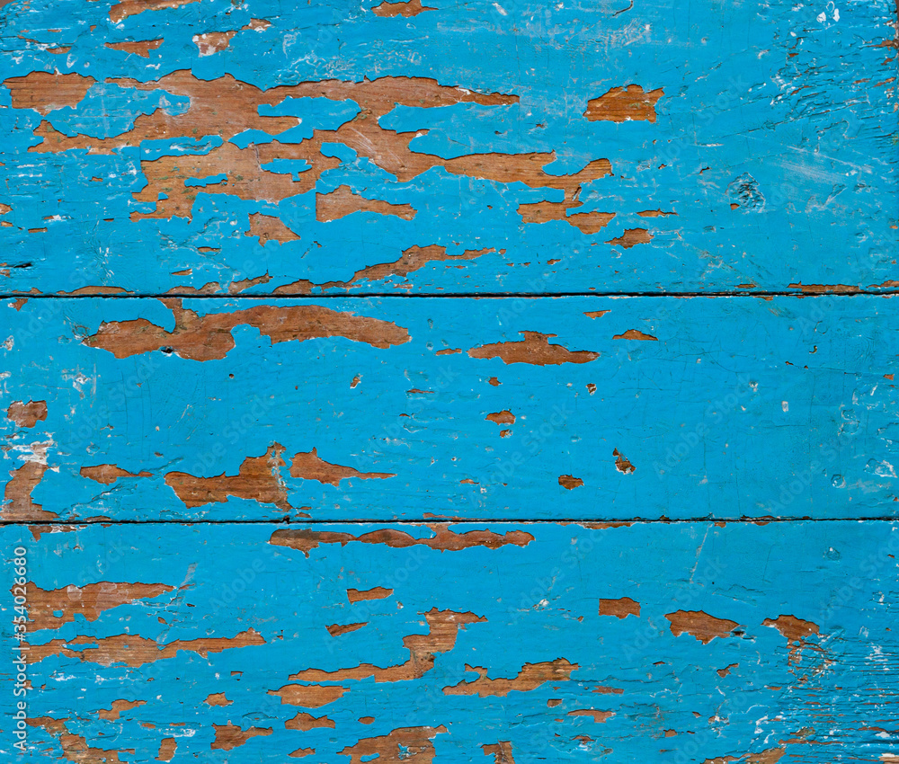 The texture of old shabby boards painted with blue paint. Tree in the loft style.