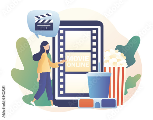 Online cinema concept. Mobile movie theater. Tiny woman watching movie at mobile app with popcorn, 3d glasses and video attributes. Modern flat cartoon style. Vector illustration on white background