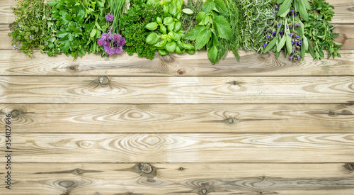 Herbs wooden background Basil parsley mint thyme dill sage