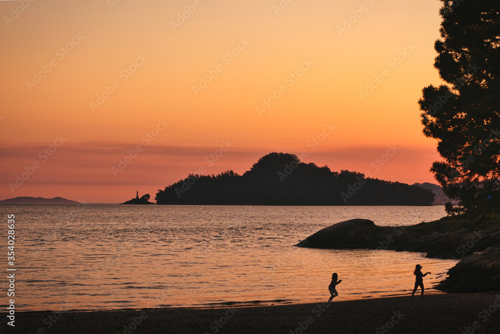 Tambo island in Ria de Pontevedra from Lourido beach in the sunset.