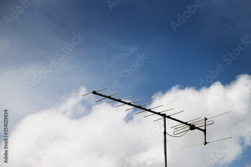 TV antenna on a background cloudy sky