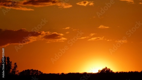 Orange sunset on the cloudy sky