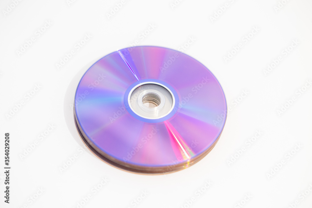 CDs DVDs - Blank recordable DVDs (DVD-R) purple discs on white background CDs DVDs - Blank recordable DVDs (DVD-R) purple discs on white background