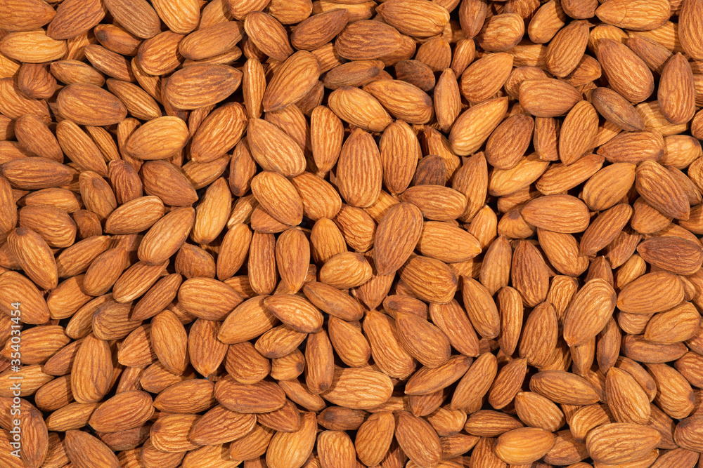 Raw peeled almonds full frame for background. Raw peeled almonds full frame for background.