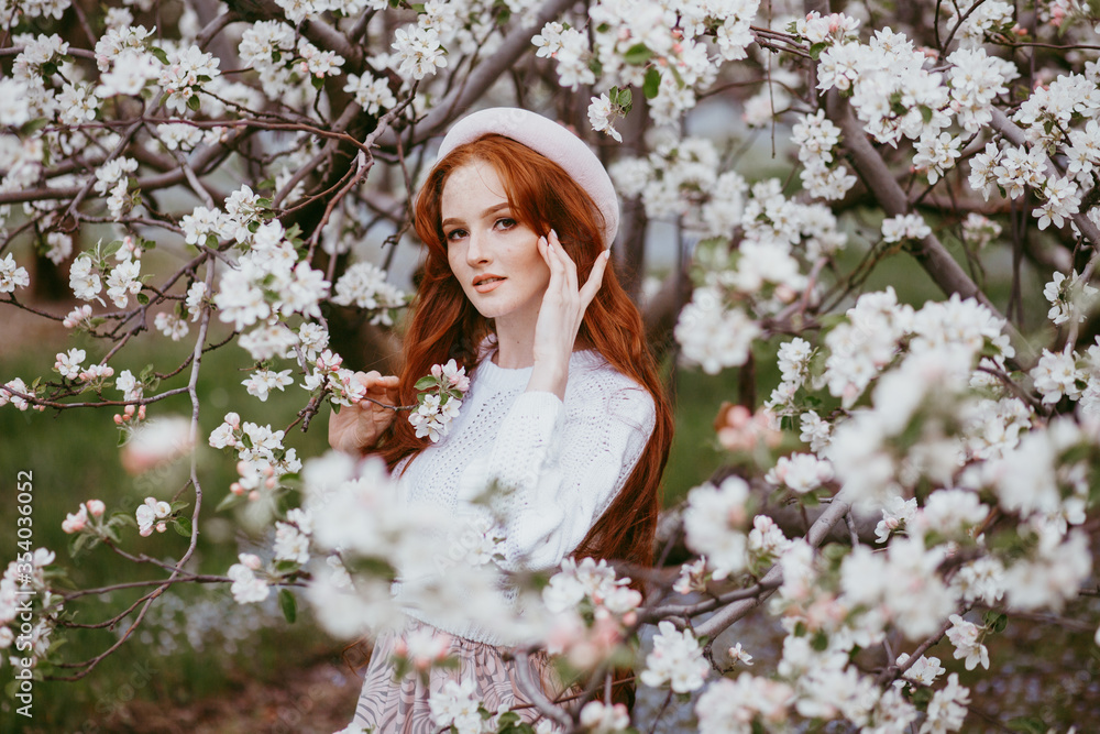 A brunette with long hair in blooming Apple orchard A brunette with long hair in blooming Apple orchard