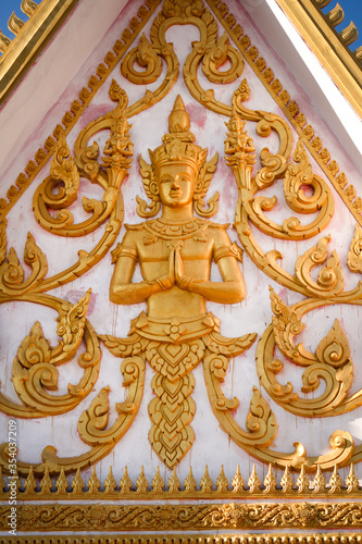 Golden fresco of a buddha image in a wat or buddhist temple site in Siamese Lao PDR, Southeast Asia