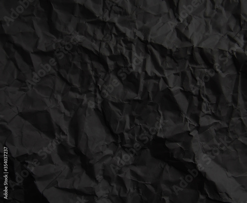 Black crumpled paper texture background © Alrika 