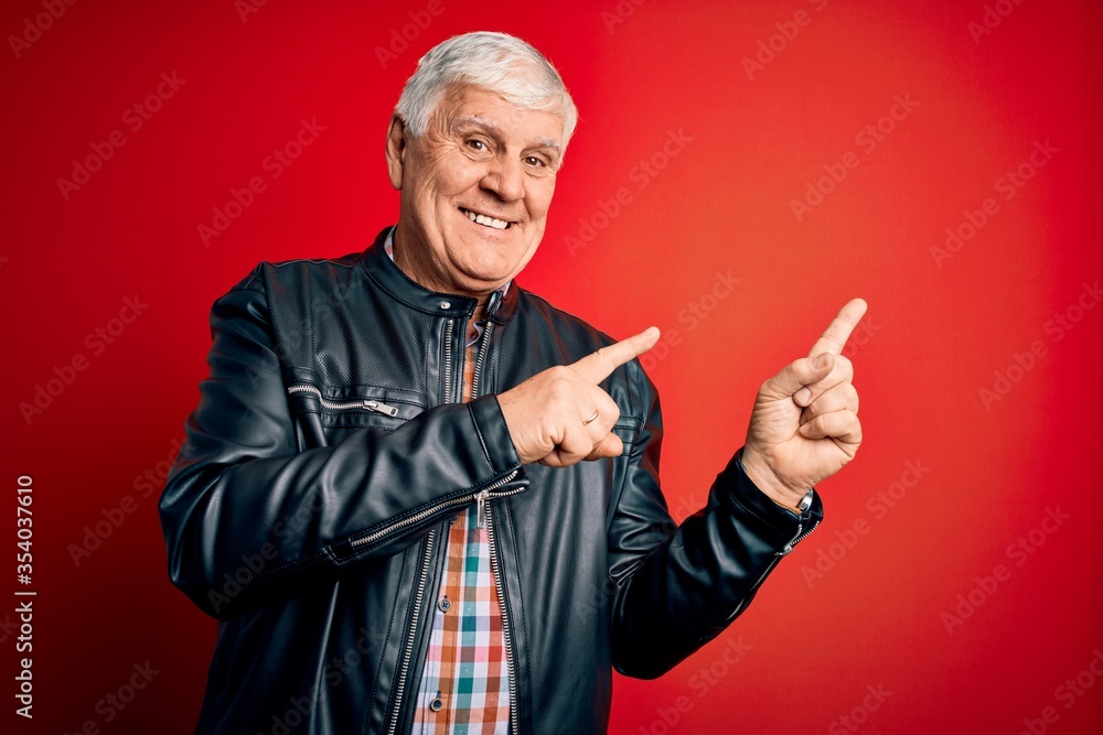 Senior handsome hoary man wearing casual shirt and jacket over isolated red background smiling and looking at the camera pointing with two hands and fingers to the side. Senior handsome hoary man wearing casual shirt and jacket over isolated red background smiling and looking at the camera pointing with two hands and fingers to the side.