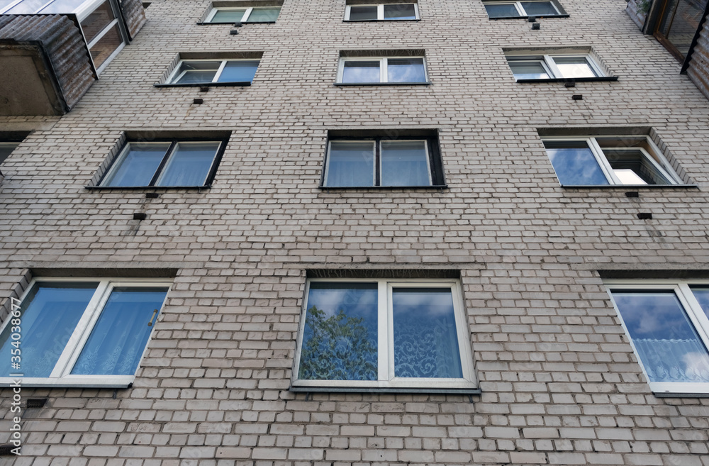 Fototapeta premium Fragment of one of the serial high-rise apartment buildings.