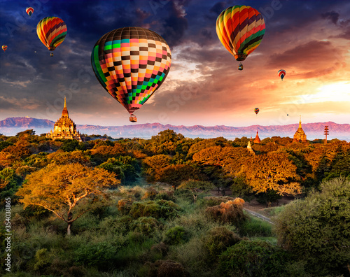 Sunrise over Bagan ruins with hot air balloons in the sky