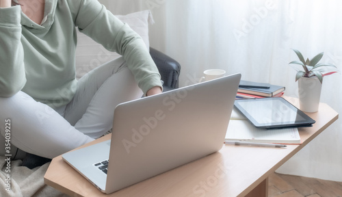 woman hands legs freelancer table sofa laptop PC home workplace © NataliAlba
