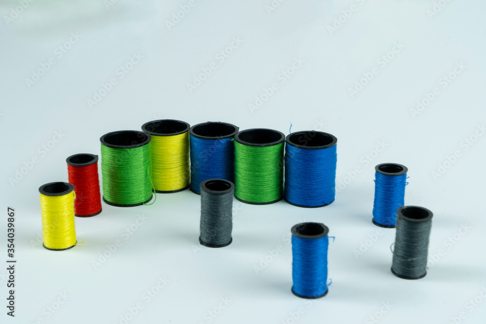 Colored spools of thread on a white background Colored spools of thread on a white background