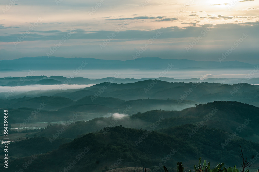 Beautiful Landscape of mountain layer in morning sun ray and winter fog at Doi Sa Ngo mountain in Chiang Saen district of Chiang Rai province of Thailand