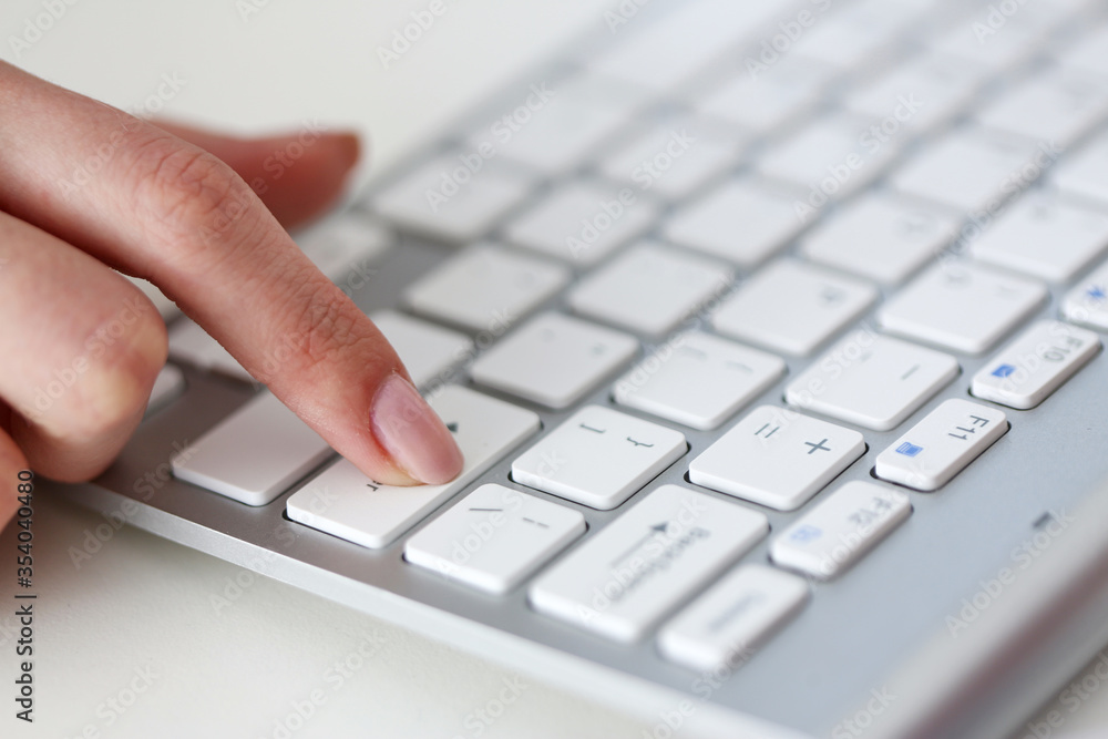 Female hands typing on silver keyboard using computer pc Female hands typing on silver keyboard using computer pc
