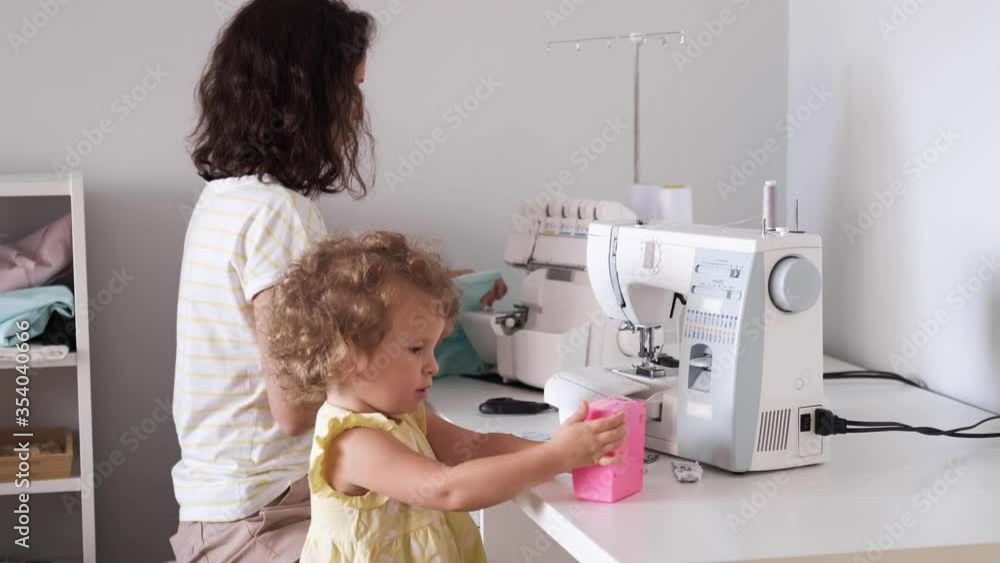 Mother multitasking, working at home with her baby. Candide genuine and real life mom works and parenting. Self-isolation. Mother multitasking, working at home with her baby. Candide genuine and real life mom works and parenting. Self-isolation.