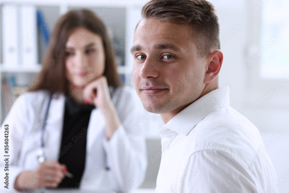 Satisfied happy handsome smiling male patient with doctor Satisfied happy handsome smiling male patient with doctor