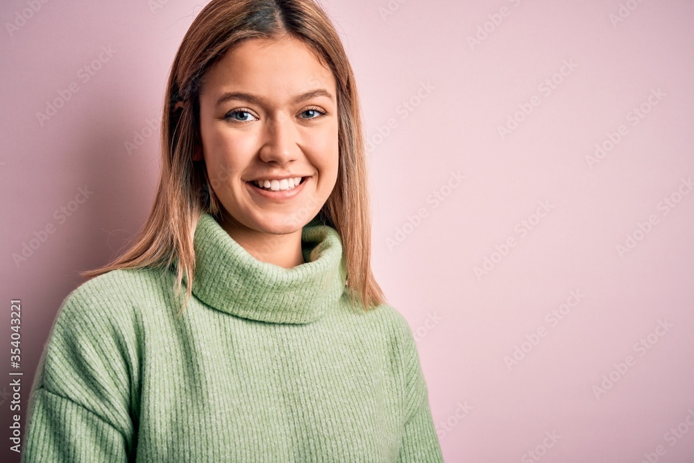 Fototapeta premium Young beautiful blonde woman wearing winter wool sweater over pink isolated background with a happy and cool smile on face. Lucky person.