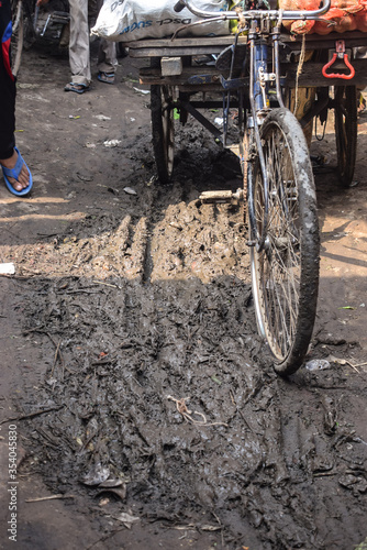 Cycle Rikshaw stuck in mud and dirt