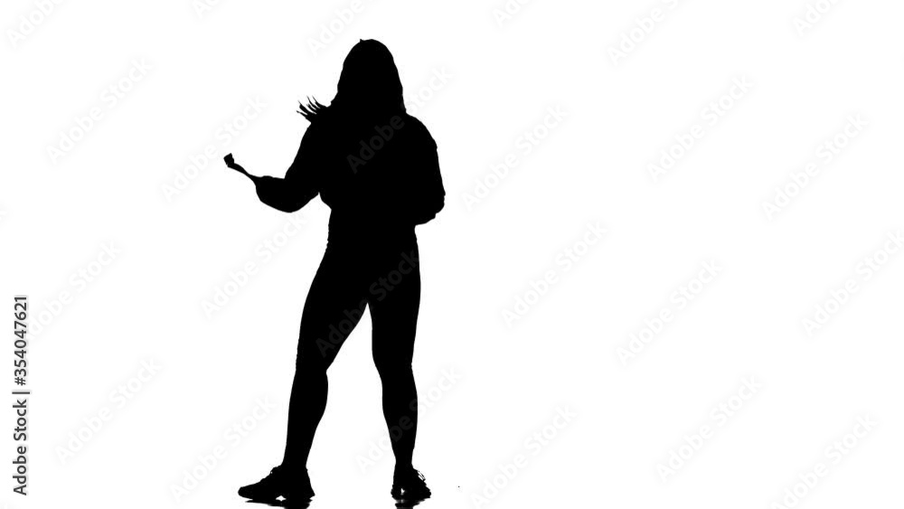 Attractive girl modern style dancer performing. Black silhouette on a white background. Contemporary choreography. Long shot Attractive girl modern style dancer performing. Black silhouette on a white background. Contemporary choreography. Long shot
