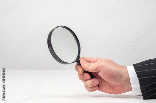 Magnifying glass in a man h...