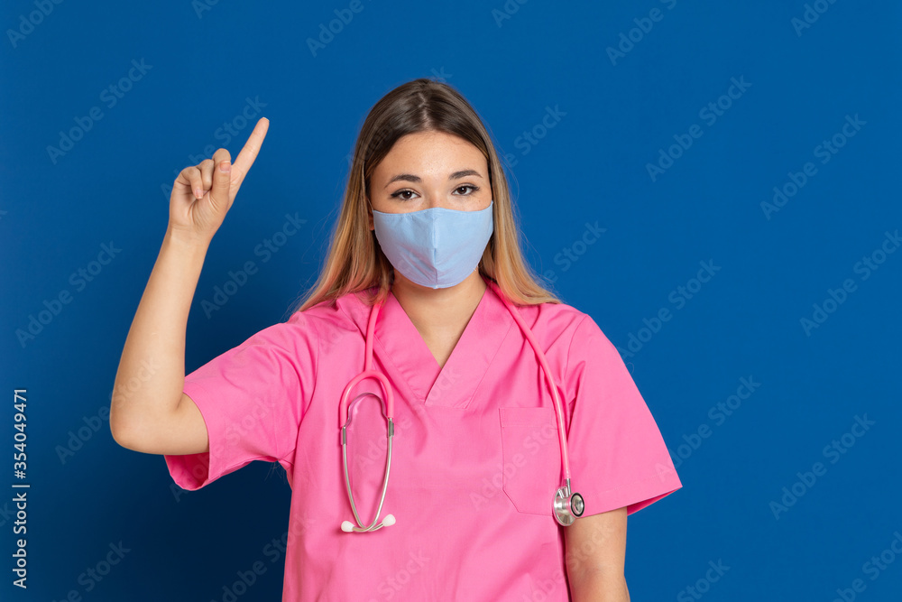 Young doctor wearing a mask face and a pink uniform Young doctor wearing a mask face and a pink uniform