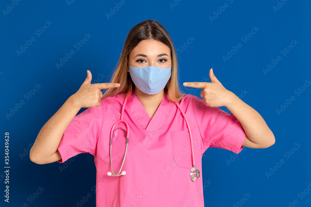 Young doctor wearing a mask face and a pink uniform Young doctor wearing a mask face and a pink uniform