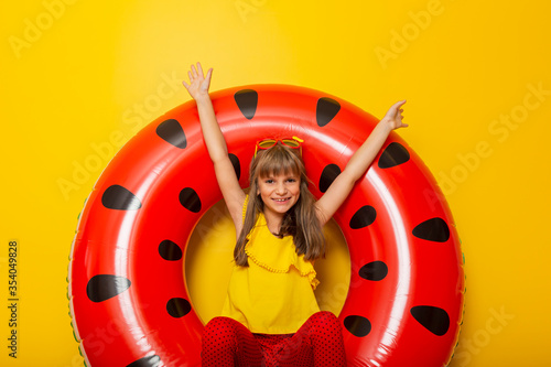 Child playing with inflatable watermelon shaped swim ring © Impact Photography