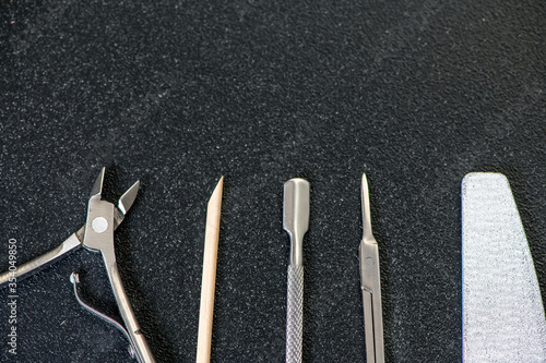 tools for manicure at home  on a black table  place for text on top