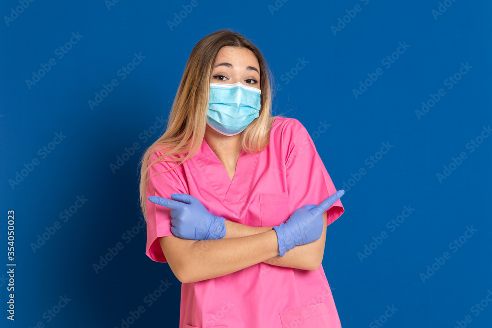 Young doctor wearing a mask face and a pink uniform Young doctor wearing a mask face and a pink uniform