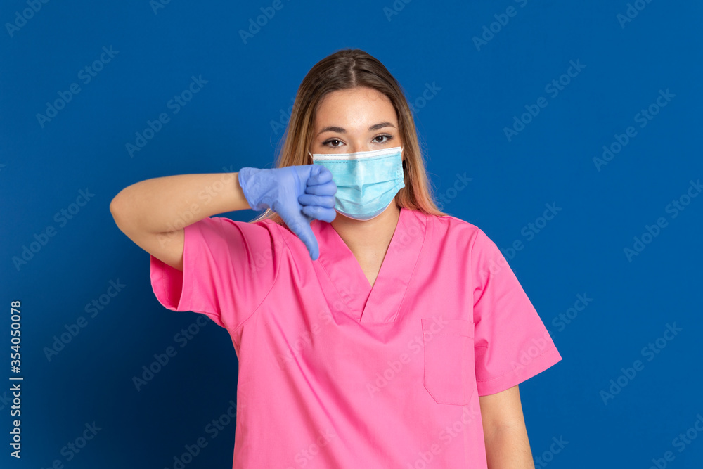 Young doctor wearing a mask face and a pink uniform Young doctor wearing a mask face and a pink uniform