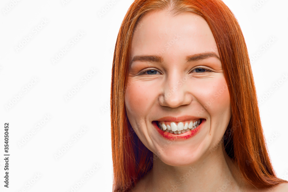 close beauty portrait of a red-haired girl with clean skin and various emotions. Isolated on a white background. close beauty portrait of a red-haired girl with clean skin and various emotions. Isolated on a white background.