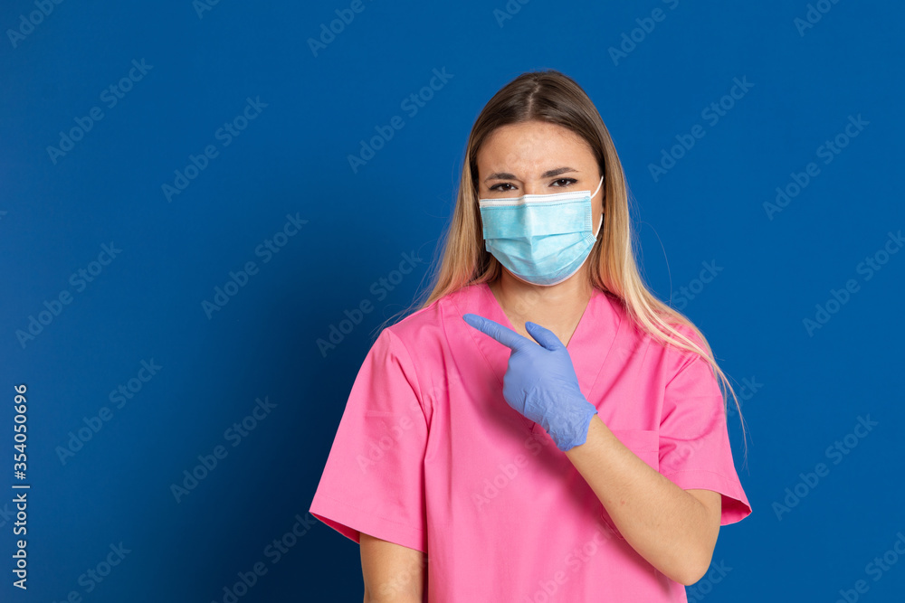 Young doctor wearing a mask face and a pink uniform Young doctor wearing a mask face and a pink uniform