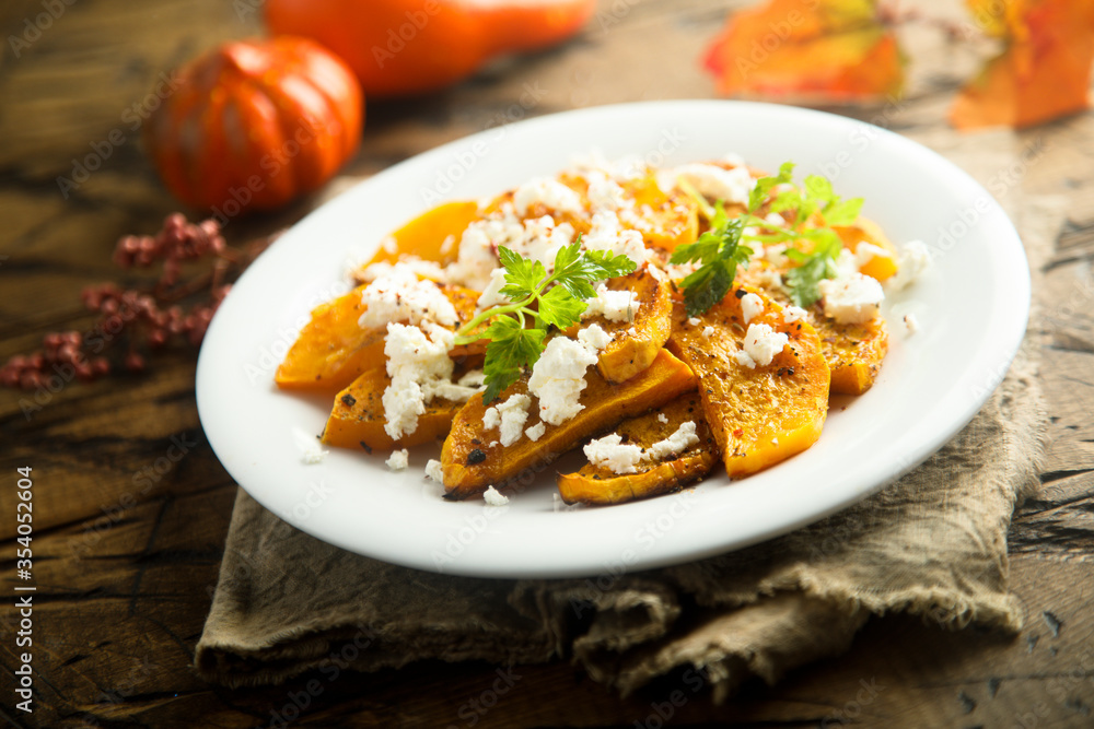 Roasted pumpkin with spices and fresh cheese