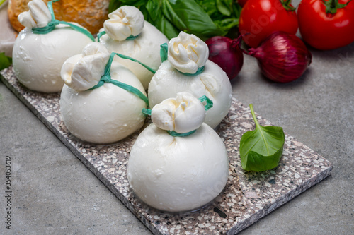 Cheese collection, fresh soft Italian cheese from Puglia, white balls of burrata or burratina cheese made from mozzarella and cream filling