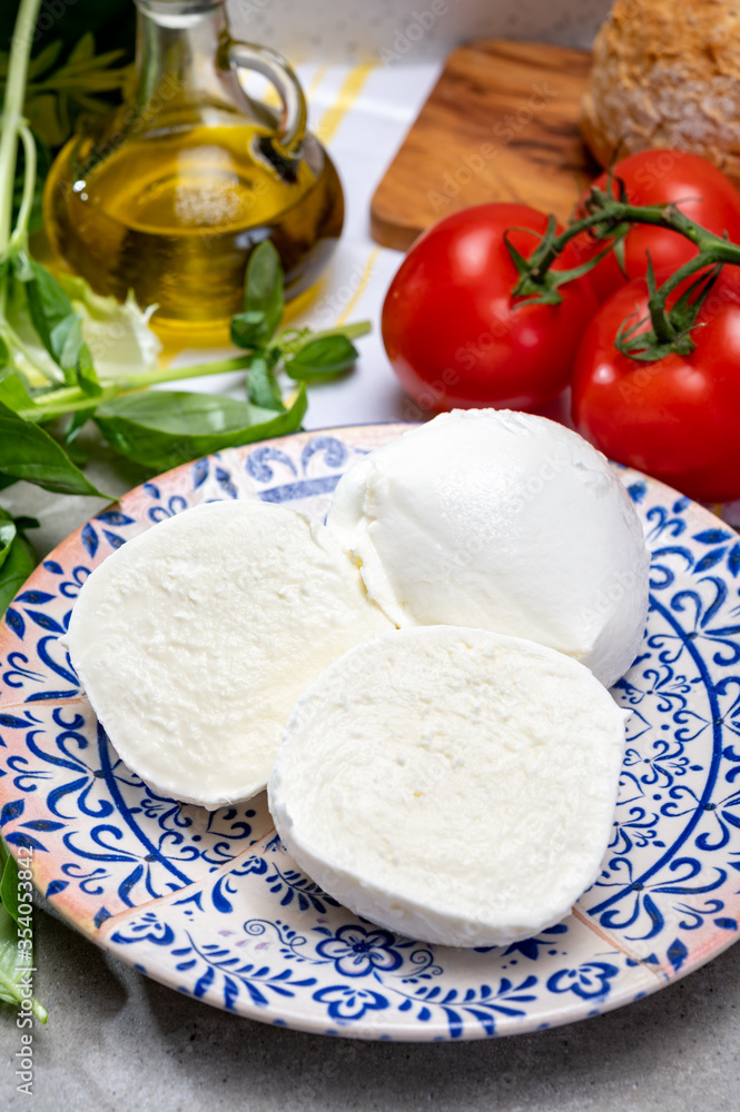 Fresh handmade soft Italian cheese from Campania, white balls of buffalo mozzarella cheese made from cow milk ready to eat Fresh handmade soft Italian cheese from Campania, white balls of buffalo mozzarella cheese made from cow milk ready to eat