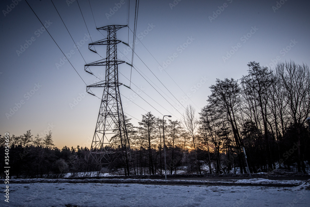 Power line in frosty winter evening sunset