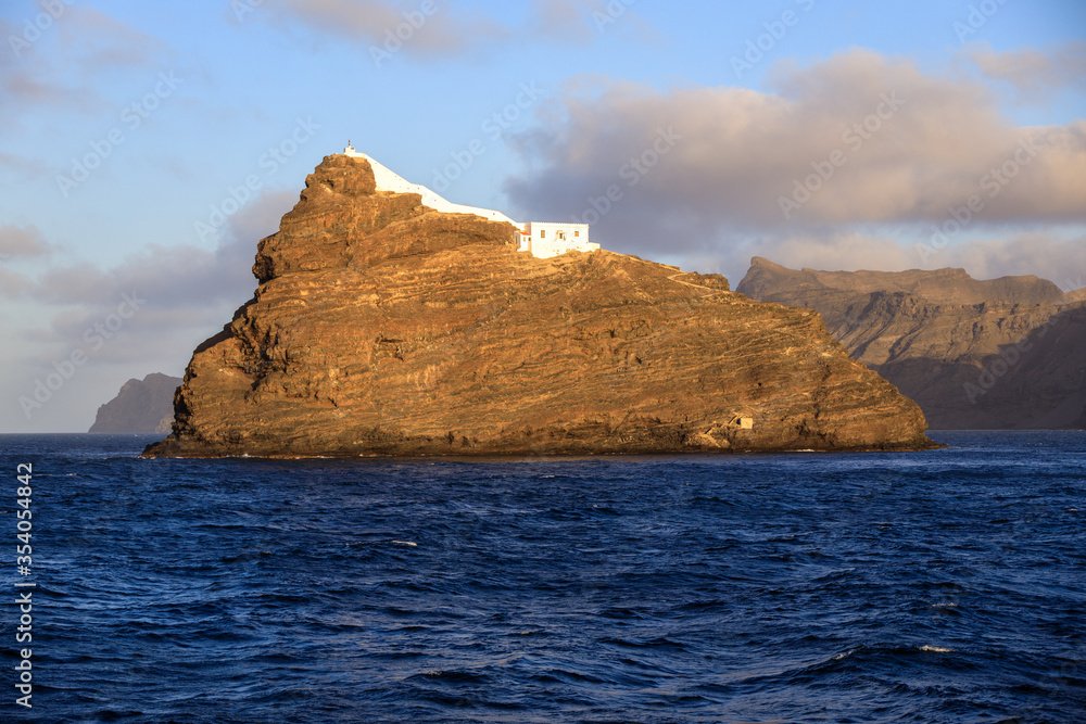 Ilhéu dos Pássaros islet in the bay of Mindelo, Sao Vicente Island, Cape Verde with a lighthouse seen from a ferry