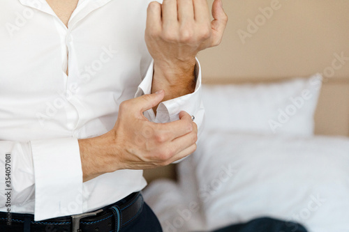 close up of a hand man wears white shirt and cufflink
