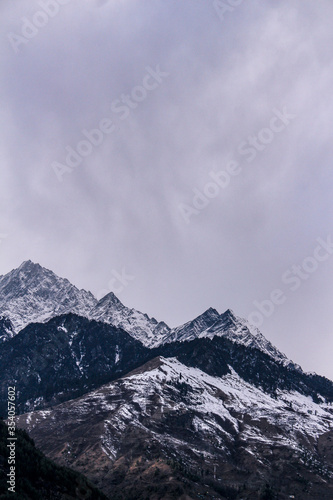 Landscape of mountain range covered with snow in Manali during summers. Mountain peak in snow. © Yogendra