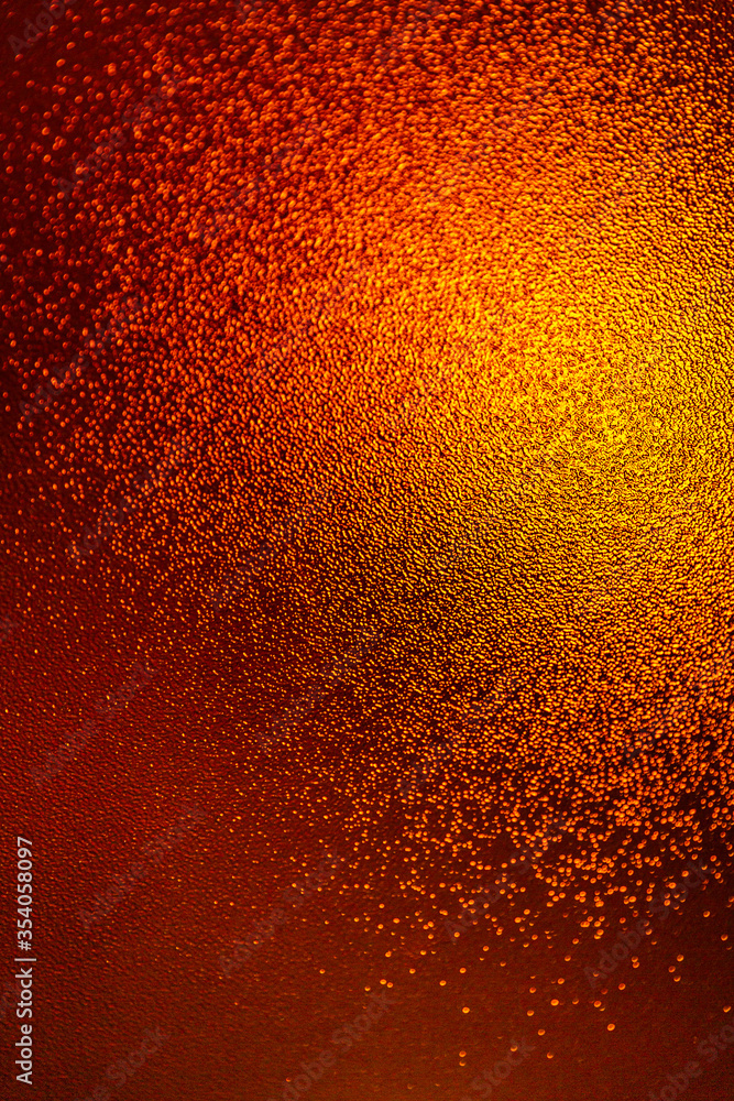 Closeup view of sparkling orange glitter background. metallic shimmer texture of material, glimmering wall background