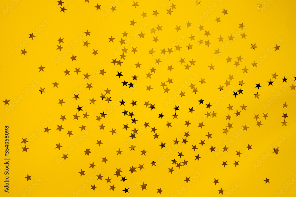 Small golden stars on a bright yellow background.