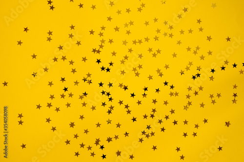 Small golden stars on a bright yellow background.