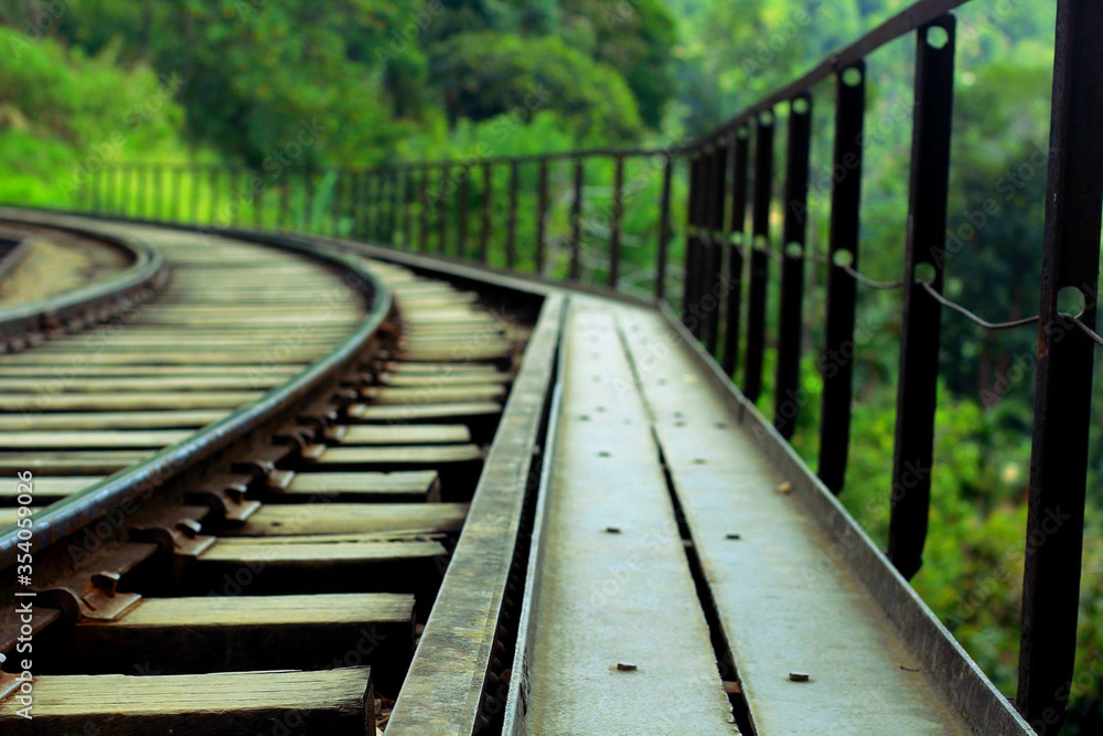 Metallic curved rails on the bridge illustrate high technology in colonial-era railway construction in the Sri Lanka. Metallic curved rails on the bridge illustrate high technology in colonial-era railway construction in the Sri Lanka.